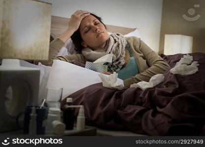Sick woman in bed suffering from flu headache
