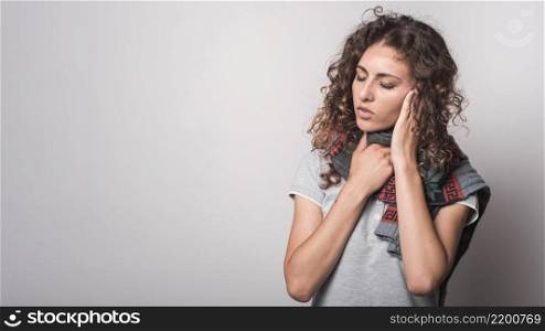 sick woman with woolen scarf around her neck suffering from flu