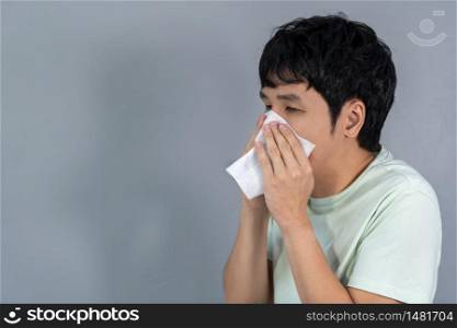 sick young man is sneezing