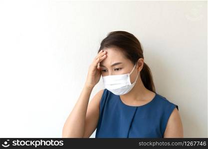 Sick young woman in medical face mask suffer in headache because of air pollution in the city building, concept of pollution,dust allergies. close up and copy space