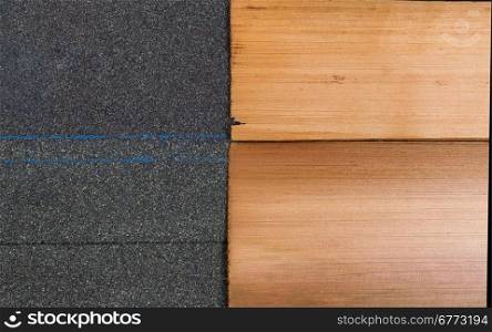 Side by side comparison of high quality new composite and cedar shake shingles in horizontal format.