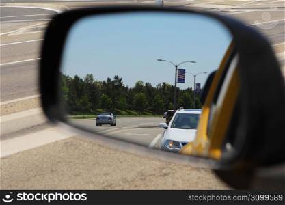 side mirror view of a road