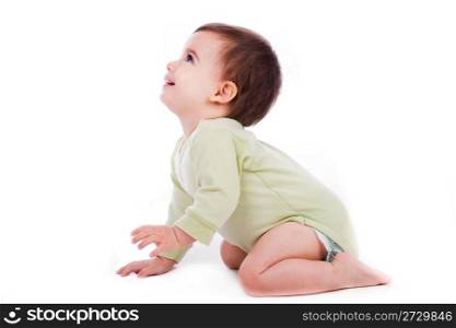 Side pose of baby sitting and looking up in white background