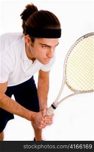 side pose of male playing tennis on an isolated background