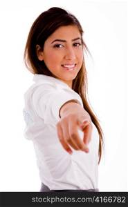 side pose of smiling businesswoamn pointing against white background