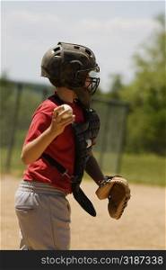 Side profile of a baseball catcher throwing a baseball