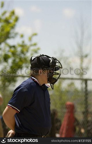 Side profile of a baseball umpire wearing a helmet