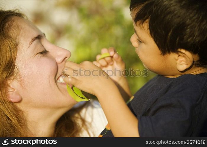 Side profile of a boy and his mother playing