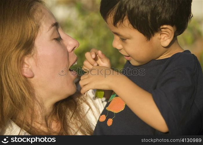 Side profile of a boy and his mother playing