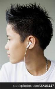 Side profile of a boy listening to headphones