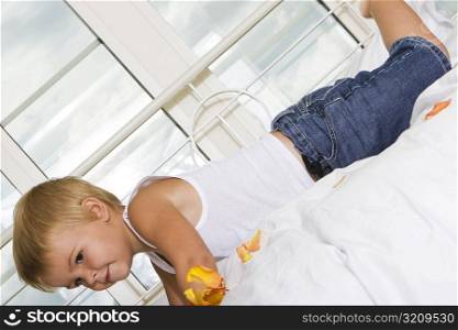 Side profile of a boy lying on the bed