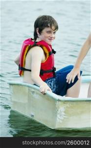 Side profile of a boy sitting in a boat