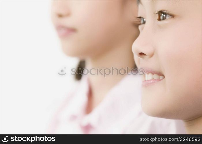 Side profile of a boy smiling with his sister