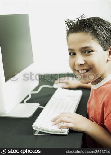 Side profile of a boy working on a computer