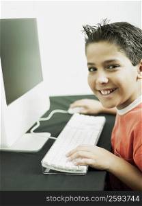 Side profile of a boy working on a computer