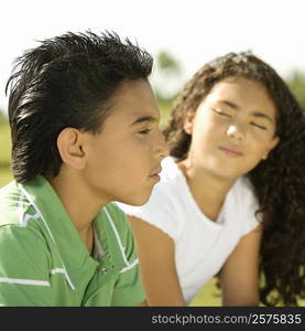 Side profile of a brother and his sister sitting together