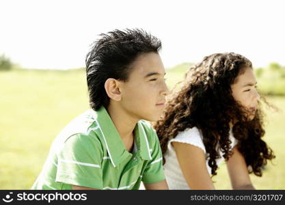 Side profile of a brother and his sister sitting together