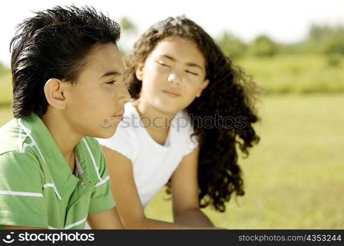 Side profile of a brother and his sister sitting together