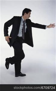 Side profile of a businessman dancing