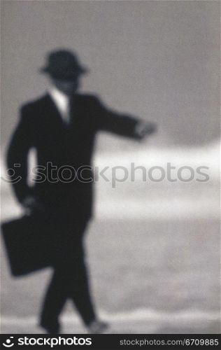 Side profile of a businessman holding a briefcase