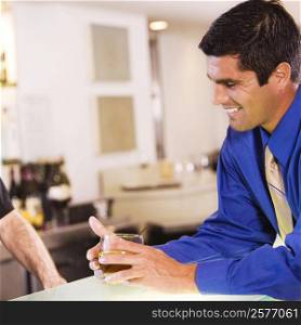 Side profile of a businessman holding a glass