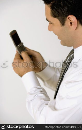 Side profile of a businessman holding a mobile phone