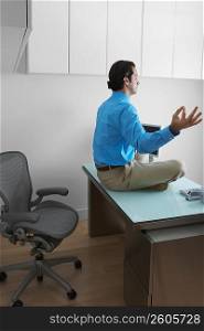 Side profile of a businessman meditating in an office