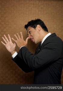 Side profile of a businessman pulling his face