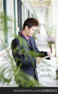 Side profile of a businessman reading a mail