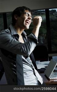 Side profile of a businessman screaming in an office