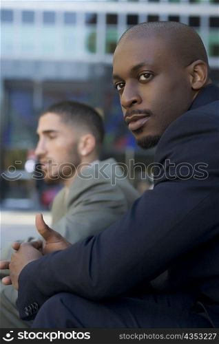 Side profile of a businessman sitting and thinking