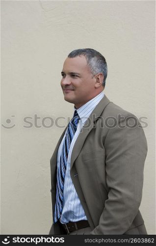 Side profile of a businessman standing and smiling