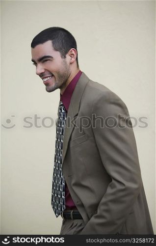 Side profile of a businessman standing and smiling