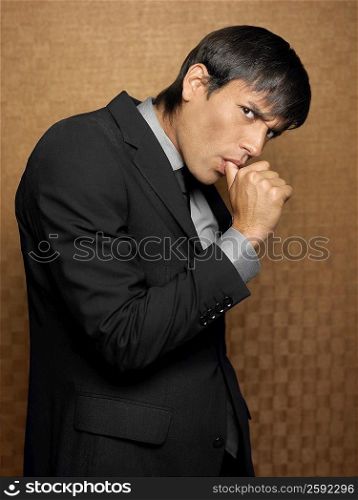 Side profile of a businessman sucking his thumb