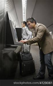 Side profile of a businessman surfing internet at an airport