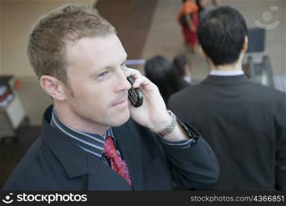 Side profile of a businessman talking on a mobile phone