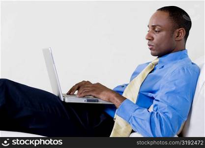 Side profile of a businessman using a laptop