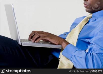 Side profile of a businessman using a laptop