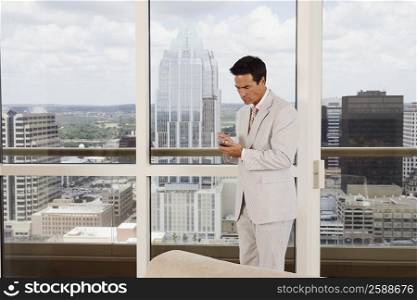 Side profile of a businessman using a personal data assistant