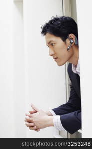 Side profile of a businessman wearing a hands-free device