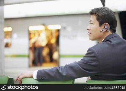Side profile of a businessman wearing a hands free device