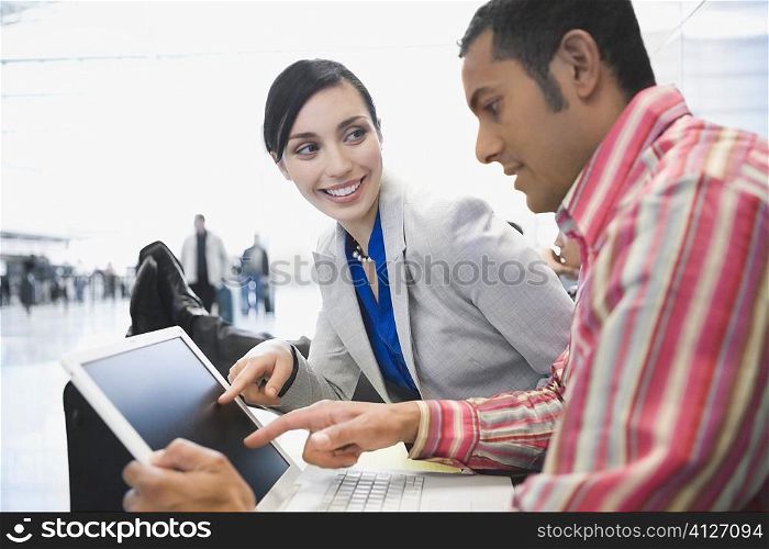 Side profile of a businessman with a businessman using a laptop