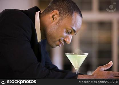 Side profile of a businessman with a glass of martini
