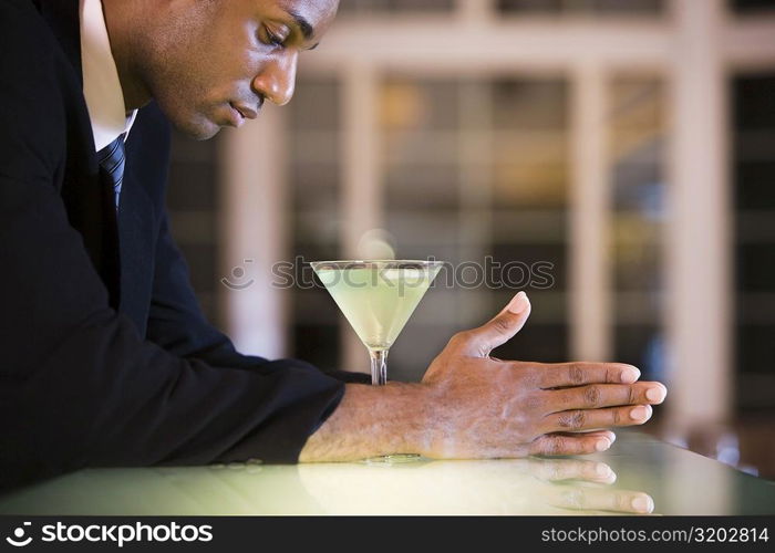 Side profile of a businessman with a glass of martini