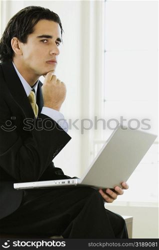Side profile of a businessman with a laptop