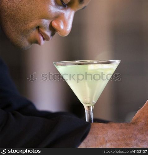 Side profile of a businessman with a martini in front of him