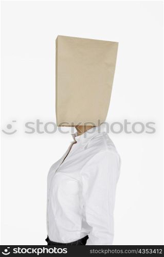 Side profile of a businesswoman covering her face with a paper bag
