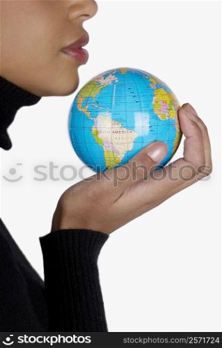 Side profile of a businesswoman holding a globe