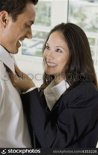 Side profile of a businesswoman looking at a businessman and smiling