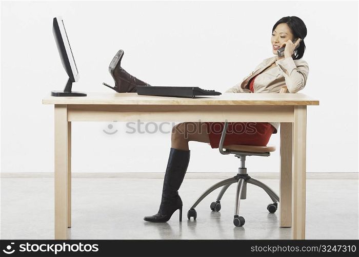 Side profile of a businesswoman talking on a cordless telephone